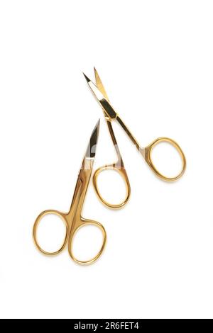 Small gold manicure scissors isolated on white background. Top view Stock Photo