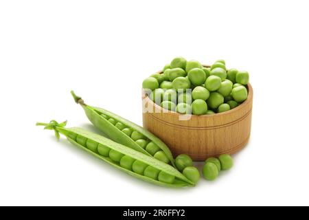 Fresh green peas in bowl isolated on white background. Top view Stock Photo