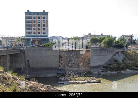 Damaged dam, broken concrete, river. Turkish city Antakya in Hatay province, earthquake aftermath. Turkey Stock Photo