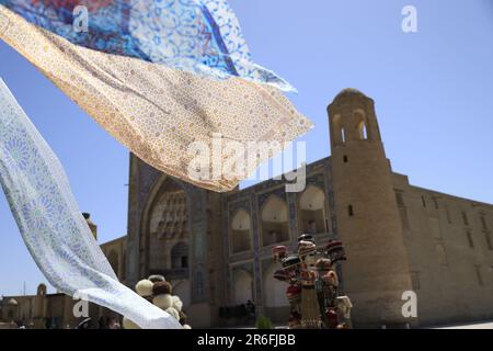 Silk drapes blowing in the wind in the historic center of Bukhara, Uzbekistan Stock Photo