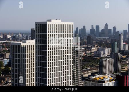 Canary Wharf skyline, financial district of the docklands area of East London on a hot summers day view from a high rise building in Stratford, London. Stock Photo