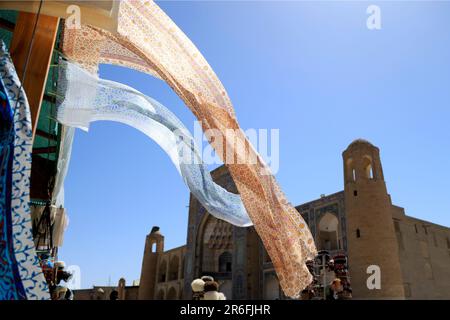 Silk drapes blowing in the wind in the historic center of Bukhara, Uzbekistan Stock Photo