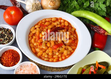 Traditional delicious Turkish foods; Dried bean (Kuru fasulye). Hot turkish bean stew with a tasty tomato sauce. Haricot. Stock Photo