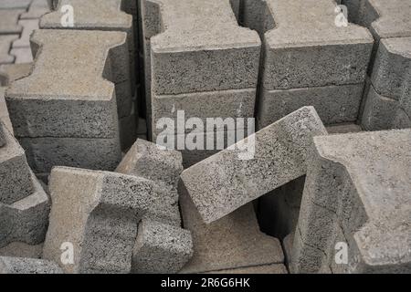 Paving slabs stacked in a pile, road repair process, close-up, selective focus on tiles, seasonal reconstruction of pavement in walking paths in parks Stock Photo