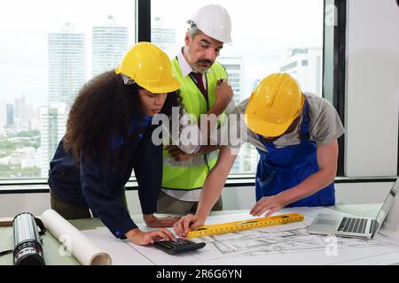 Construction engineers team using blueprint of project plan Stock Photo