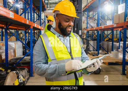 Warehouse workers checking and controlling boxes in warehouse Stock Photo