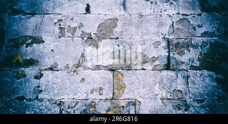 An old white brick wall with chipped paint. Vintage camera effect added to image Stock Photo