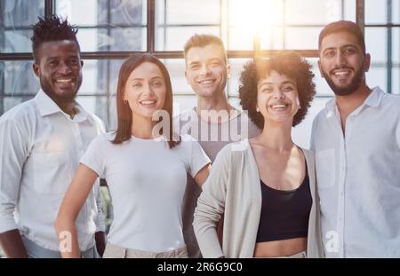 Portrait of successful creative business team looking at camera and smiling. Diverse business people standing together at startup. Stock Photo