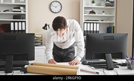 Young hispanic man architect drawing house plans at office Stock Photo