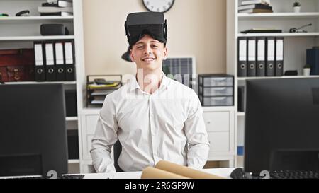 Young hispanic man architect wearing virtual reality glasses smiling at office Stock Photo
