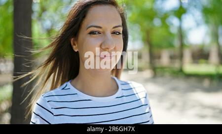 Middle eastern woman standing with serious expression at park Stock Photo