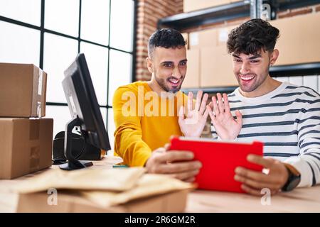 Two man ecommerce business workers having video call working at office Stock Photo