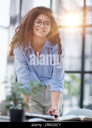 A young woman makes a report in the office. Woman writing notes for educational project in business Stock Photo