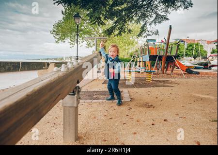 Funny toddler boy having fun on playground Stock Photo