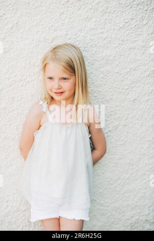 Outdoor summer portrait of adorable 5 year old little girl wearing