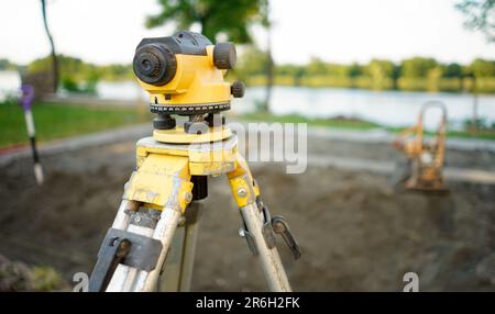 Surveyor equipment theodolite on the construction site. Land surveying with optical measurement tools. Theodolite on the site. Measurement on construc Stock Photo