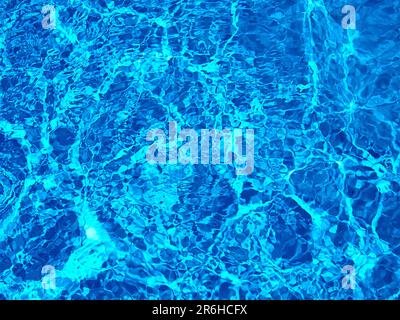 Abstract design of turquoise swimming pool water with sunshine reflection Stock Photo