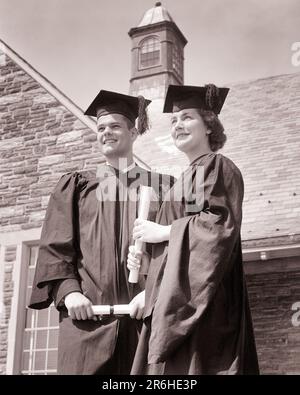 1950s 1950s BOY AND GIRL GRADUATES HOLDING DIPLOMAS WEARING CAP AND GOWN - s9162 HAR001 HARS SUBURBAN MOTHERS OLD TIME FUTURE GRADUATE NOSTALGIA BROTHER OLD FASHION SISTER 1 JUVENILE COMMUNICATION YOUNG ADULT STRONG SONS JOY LIFESTYLE SATISFACTION CELEBRATION FEMALES MARRIED BROTHERS DIPLOMA SPOUSE HUSBANDS COPY SPACE FRIENDSHIP HALF-LENGTH LADIES PERSONS INSPIRATION CARING MALES TEENAGE GIRL TEENAGE BOY GRADUATING SIBLINGS CONFIDENCE SISTERS GRADUATES B&W PARTNER GOALS SUCCESS HAPPINESS UNIVERSITIES AND LOW ANGLE PRIDE HIGH SCHOOL SIBLING HIGH SCHOOLS HIGHER EDUCATION CONNECTION COLLEGES Stock Photo