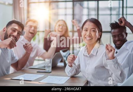 group of different business people celebrating victory while Stock Photo