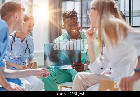 Young group of oral surgeons looking at x-ray while preparing for surgery procedure. Stock Photo