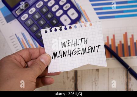 Wealth management is shown using a text and pictures of dollars. Stock Photo