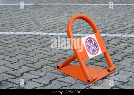 Parking barrier with No Stopping road sign on pavement outdoors, space for text Stock Photo