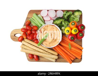 Board with delicious hummus, grissini sticks and fresh vegetables on white background, top view Stock Photo