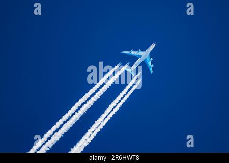 Sharp telephoto close up of jet plane aircraft with contrails cruising