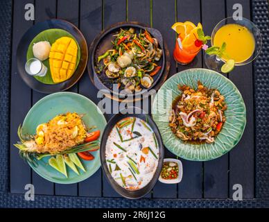 Thai food dishes in a restaurant beachfront in Hua Hin, Thailand Stock Photo
