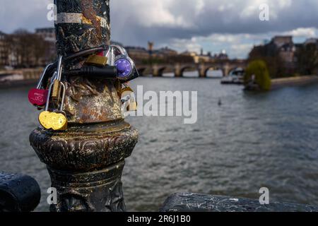 Love locks on a lamp post in Paris, France with river Seine in the background in spring Stock Photo