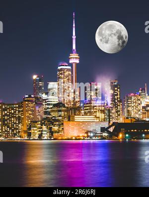 A full moon rising over Toronto in Canada long exposure Stock Photo