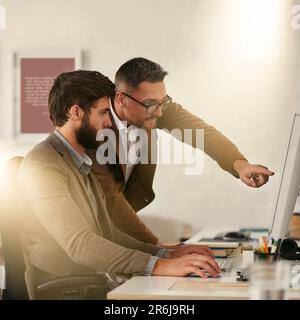 Creative businessman, team and coaching intern on computer in web design, UX or UI at the office. Man designer training staff or student on PC for Stock Photo