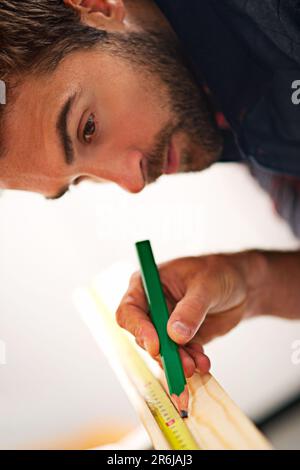 Carpenter, wood and planning with man in workshop for building, manufacturing and creative. Design, industry and woodworker with handyman measuring on Stock Photo