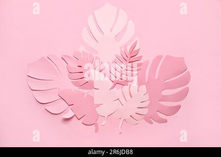 Different paper tropical leaves on pale pink background Stock Photo