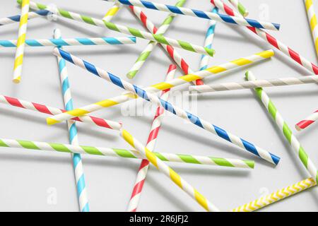 Different paper drinking straws on blue background Stock Photo