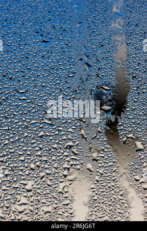Heavy rain and condensation on a window, the colours are from out of focus vehicles on the far side of the glass Stock Photo