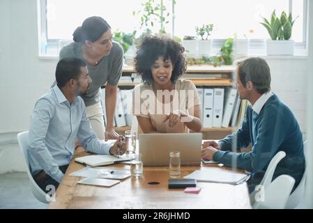 Discussion, laptop and business people in the office planning a project together in boardroom. Meeting, teamwork and professional web designers Stock Photo