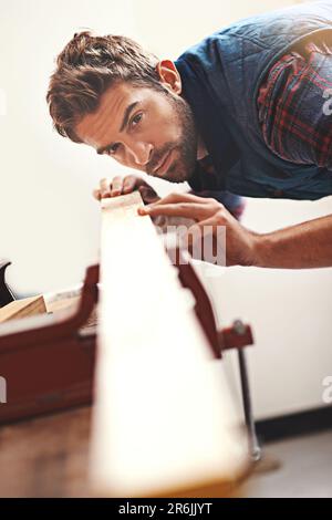 Carpenter, wood and planning with man in workshop for building, manufacturing and creative. Design, industry and woodworker with handyman measuring on Stock Photo
