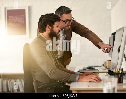 Creative businessman, teamwork and coaching intern on computer in web design, UX or UI at the office. Man designer training staff or student on PC for Stock Photo