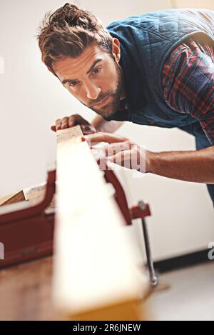 Carpenter, wood and design with man in workshop for building, manufacturing and creative. Planning, industry and woodworker with handyman measuring on Stock Photo