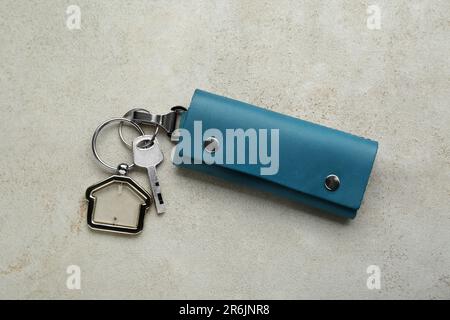 Leather case with key on light grey table, top view Stock Photo