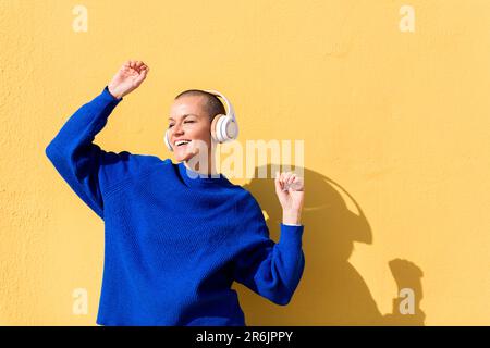 happy woman dancing listening music in headphones Stock Photo