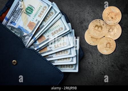 Bitcoins, dollar banknotes and wallet on black background, flat lay Stock Photo