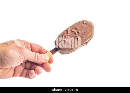 Popsicle, ice cream covered with chocolate in hand isolated on the white background. Stock Photo