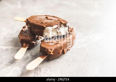 Popsicle, ice cream covered with chocolate on the kitchen table. Stock Photo