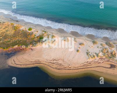 Wave patterns on the beach of a narrow sand island at Queenscliff in Victoria, Australia Stock Photo