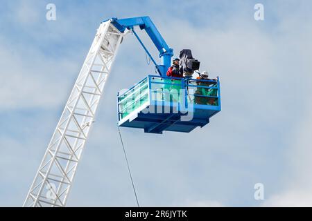 Television camera high on a crane Stock Photo
