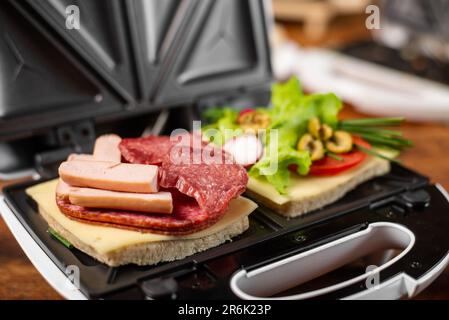 Vegetarian and meat-eating sandwich. Comparison. Sandwich stuffed with meat  sausages and ham against a stuffing of lettuce, onion, olives and tomato  Stock Photo - Alamy