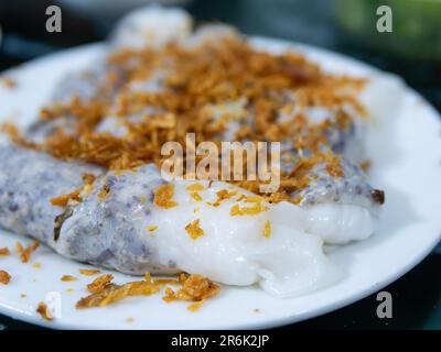 Banh cuon, rice sheet rolls with minced pork, garnished with hanh phi, crispy fried onion, a common Vietnamese breakfast, here served at a restaurant Stock Photo