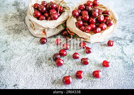Fresh ripe cherries on a table at springtime, Italy, Europe Stock Photo